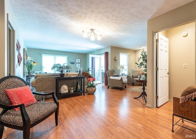 682 E Heather Dr, Bloomington, IN 47401 - sitting room featuring light wood-type flooring, healthy amount of natural light, and a textured ceiling