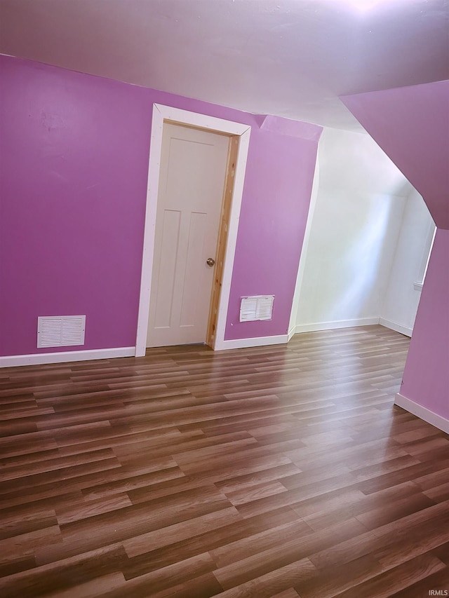 bonus room with wood finished floors and baseboards