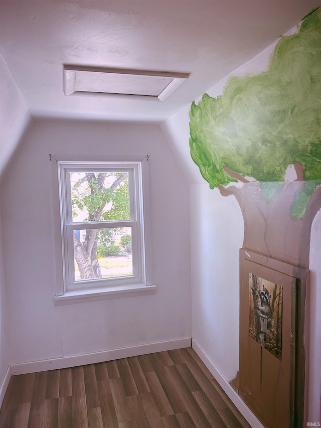 bonus room featuring lofted ceiling, dark wood finished floors, attic access, and baseboards
