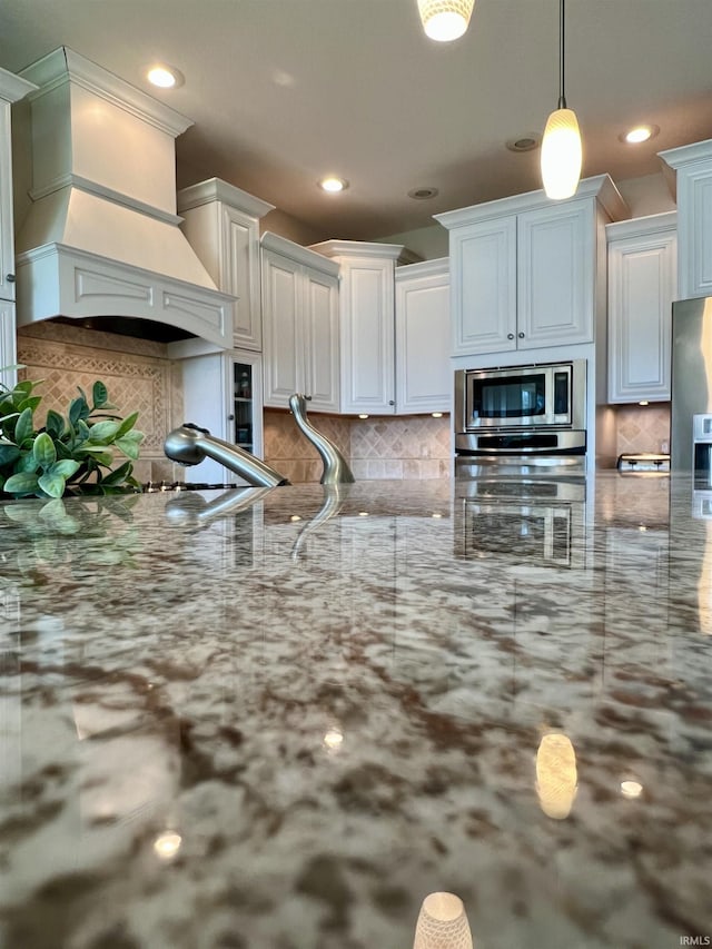 1620 Colonial Dr, Rochester, IN 46975 - kitchen with stainless steel appliances, recessed lighting, decorative backsplash, hanging light fixtures, and light stone countertops