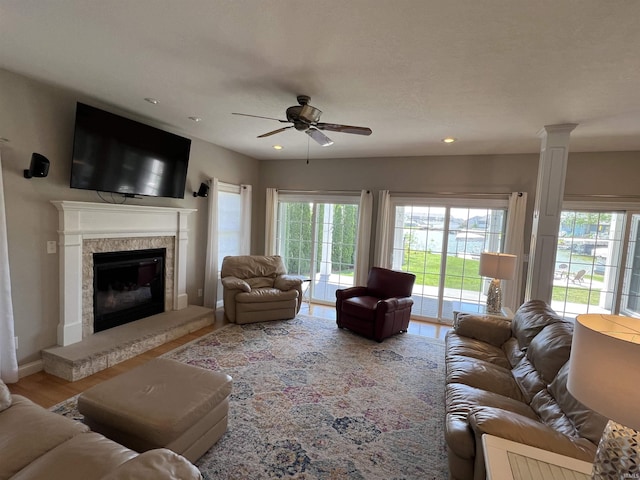 1620 Colonial Dr, Rochester, IN 46975 - living area featuring ceiling fan, healthy amount of natural light, recessed lighting, a glass covered fireplace, and wood finished floors