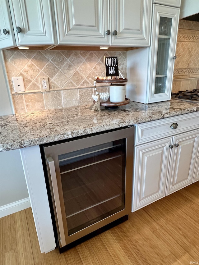 1620 Colonial Dr, Rochester, IN 46975 - bar area featuring beverage cooler, tasteful backsplash, and light wood-type flooring
