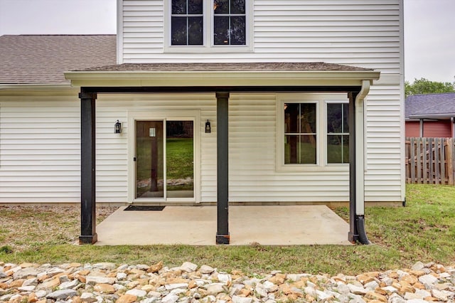 7215 W Mustang Dr, Ellettsville, IN 47429 - entrance to property featuring fence, a patio area, and roof with shingles