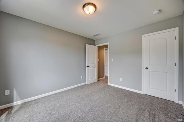 7215 W Mustang Dr, Ellettsville, IN 47429 - unfurnished bedroom with carpet flooring and baseboards