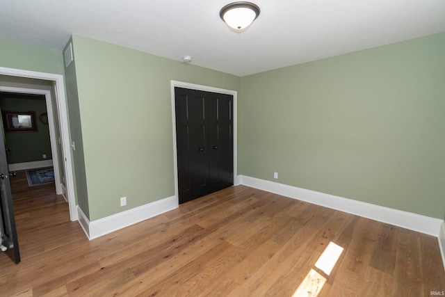 30512 Jaxon Dr, Elkhart, IN 46517 - unfurnished bedroom with a closet, baseboards, and light wood-style floors