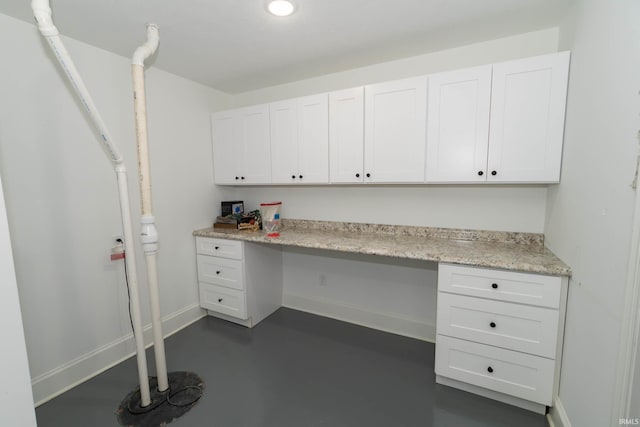 30512 Jaxon Dr, Elkhart, IN 46517 - unfurnished office with built in study area, concrete floors, and baseboards