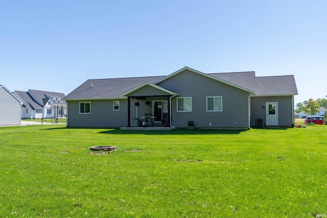 30512 Jaxon Dr, Elkhart, IN 46517 - rear view of house with a fire pit, a yard, central AC unit, roof with shingles, and a patio