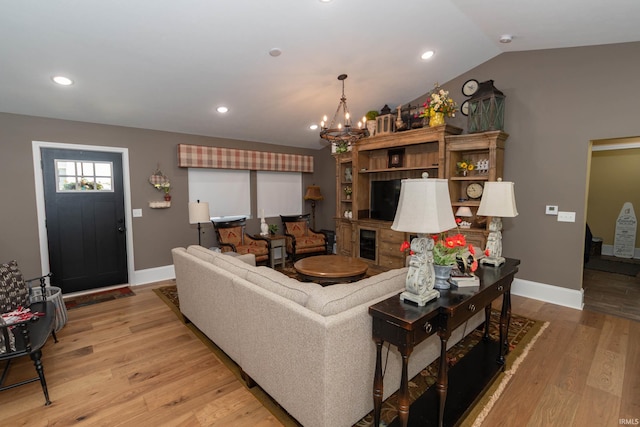 30512 Jaxon Dr, Elkhart, IN 46517 - living room featuring light wood-style flooring, a chandelier, baseboards, recessed lighting, and lofted ceiling