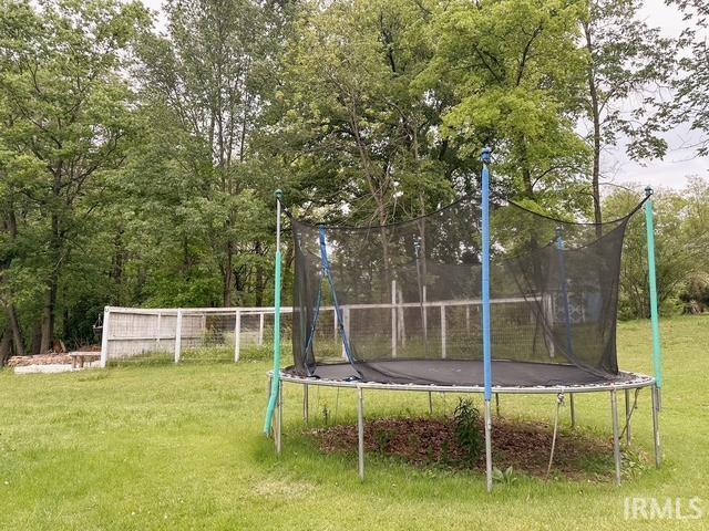 6330 Gardner Rd, Chandler, IN 47610 - view of green lawn featuring a trampoline