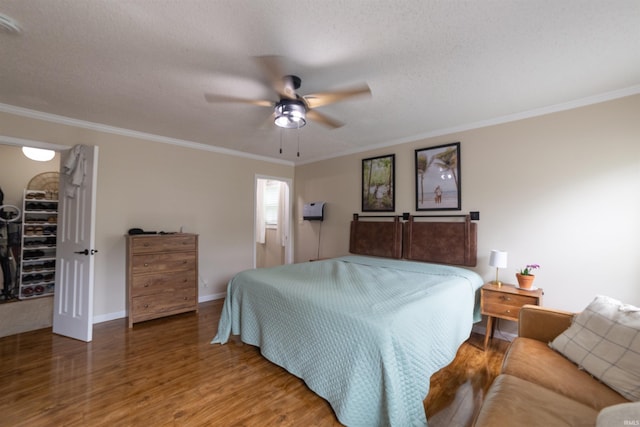 6330 Gardner Rd, Chandler, IN 47610 - bedroom with ornamental molding, wood finished floors, a walk in closet, baseboards, and a closet
