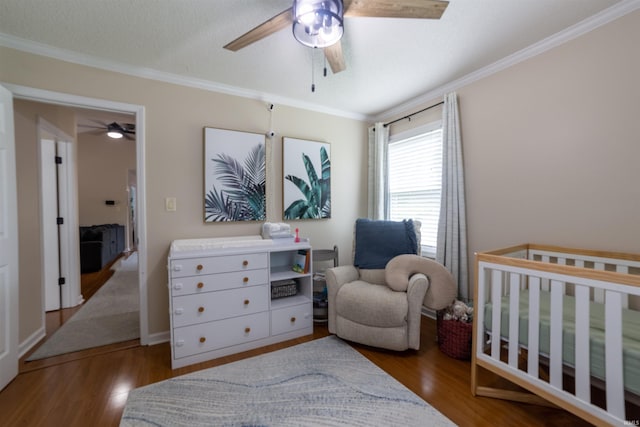 6330 Gardner Rd, Chandler, IN 47610 - bedroom featuring crown molding, wood finished floors, a nursery area, and ceiling fan