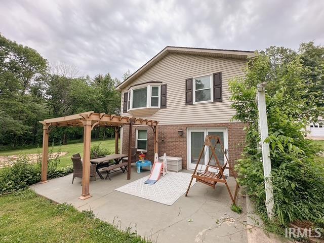 6330 Gardner Rd, Chandler, IN 47610 - back of property with a pergola, a patio area, and brick siding