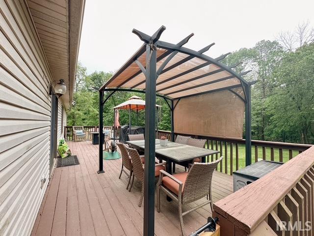 6330 Gardner Rd, Chandler, IN 47610 - wooden deck with outdoor dining area and a pergola
