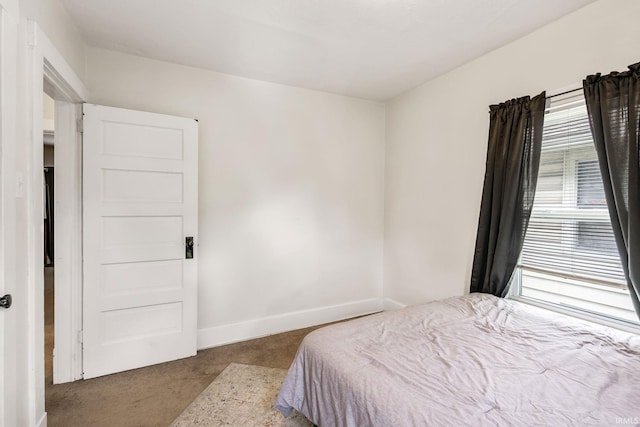 bedroom featuring carpet and baseboards