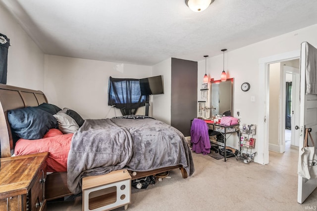 bedroom with light carpet and a textured ceiling