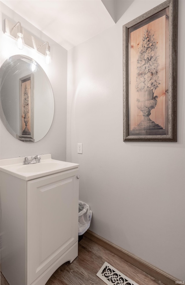 7860 Cedar Ridge Dr, Evansville, IN 47715 - bathroom featuring wood finished floors, vanity, and baseboards
