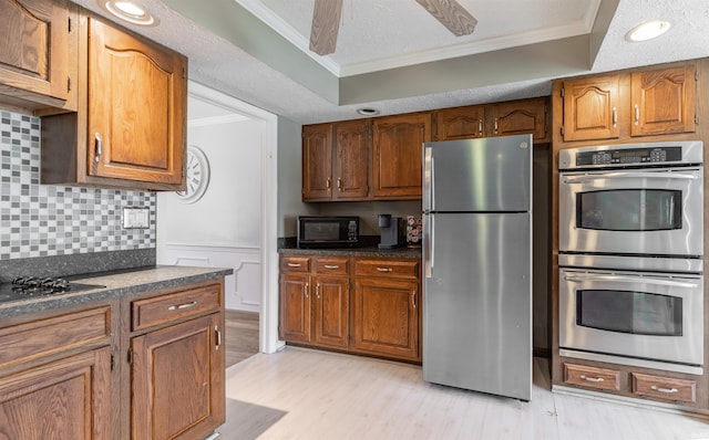 7860 Cedar Ridge Dr, Evansville, IN 47715 - kitchen featuring black appliances, ornamental molding, dark countertops, light wood-type flooring, and backsplash