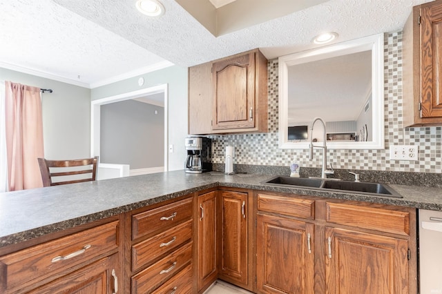 7860 Cedar Ridge Dr, Evansville, IN 47715 - kitchen featuring a sink, a textured ceiling, dark countertops, crown molding, and brown cabinetry