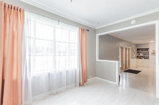 7860 Cedar Ridge Dr, Evansville, IN 47715 - spare room featuring wood finished floors, ornamental molding, a textured ceiling, baseboards, and a smoke detector