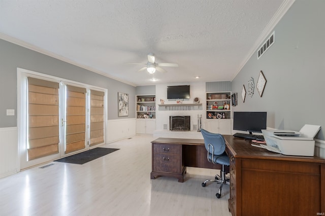 7860 Cedar Ridge Dr, Evansville, IN 47715 - home office with ceiling fan, ornamental molding, a textured ceiling, light wood-style flooring, and built in features
