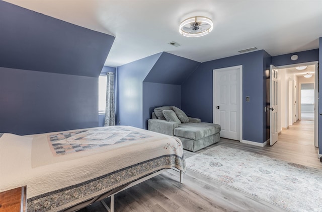 7860 Cedar Ridge Dr, Evansville, IN 47715 - bedroom featuring wood finished floors, baseboards, and vaulted ceiling