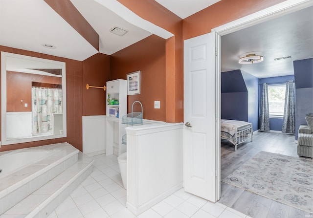 7860 Cedar Ridge Dr, Evansville, IN 47715 - ensuite bathroom featuring a garden tub, wainscoting, toilet, and a shower with curtain