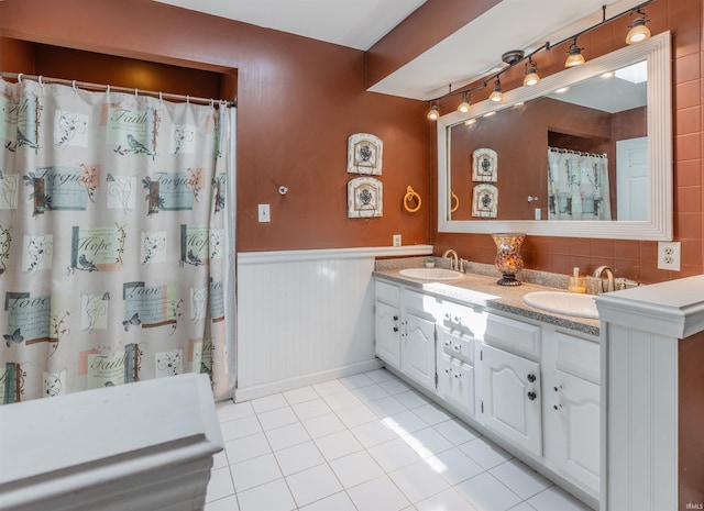 7860 Cedar Ridge Dr, Evansville, IN 47715 - bathroom featuring a wainscoted wall, tile patterned floors, double vanity, and a shower with shower curtain