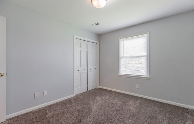 7860 Cedar Ridge Dr, Evansville, IN 47715 - unfurnished bedroom featuring carpet floors, a closet, and baseboards