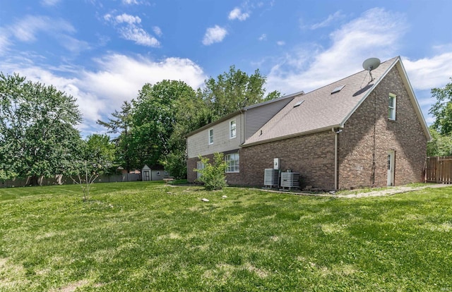 7860 Cedar Ridge Dr, Evansville, IN 47715 - rear view of house featuring a storage unit, central AC, brick siding, and an outbuilding