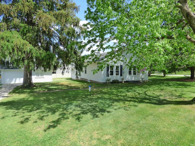 51044 Portage Rd, South Bend, IN 46628 - view of green lawn with a garage