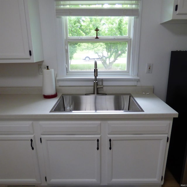 51044 Portage Rd, South Bend, IN 46628 - kitchen with a sink, white cabinets, and light countertops