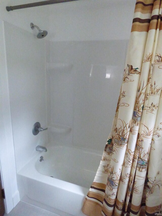 51044 Portage Rd, South Bend, IN 46628 - bathroom featuring shower / bathtub combination with curtain and tile patterned flooring