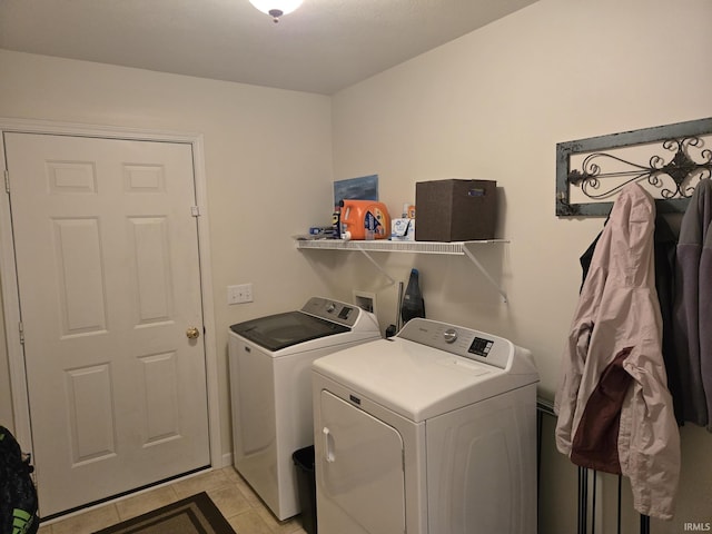 washroom featuring washing machine and clothes dryer and light tile patterned floors