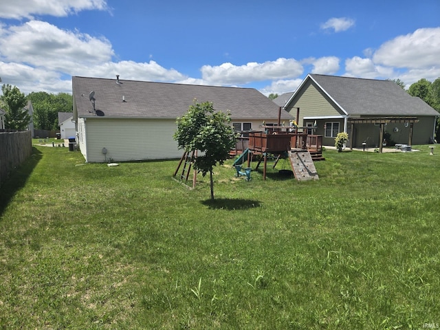 view of yard featuring a deck and a playground