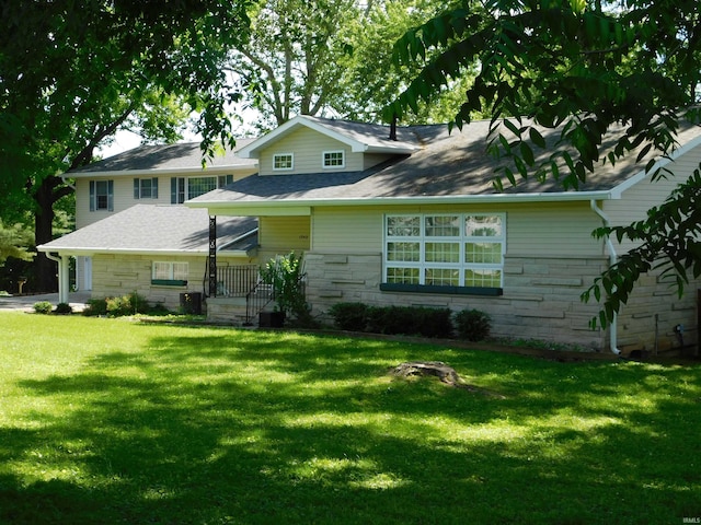 1702 Valley View Dr, Bedford, IN 47421 - view of front facade featuring stone siding, a front lawn, and central AC