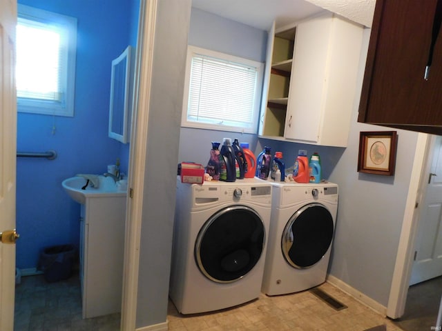 1702 Valley View Dr, Bedford, IN 47421 - laundry area featuring washer and dryer, baseboards, and cabinet space
