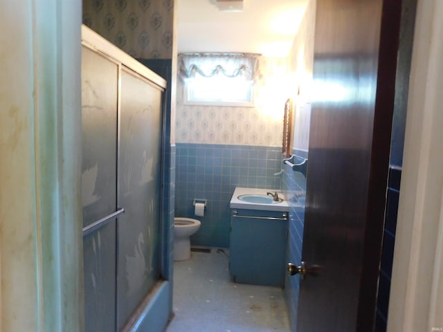 1702 Valley View Dr, Bedford, IN 47421 - full bathroom with wallpapered walls, vanity, a shower with door, wainscoting, and toilet
