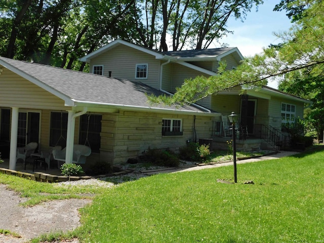 1702 Valley View Dr, Bedford, IN 47421 - view of front of property featuring a shingled roof, a front lawn, and stone siding