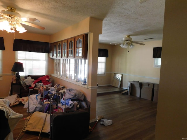 1702 Valley View Dr, Bedford, IN 47421 - living room featuring a ceiling fan, a textured ceiling, wood finished floors, and baseboards
