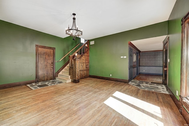4302 Kessler Blvd N Drive, Indianapolis, IN 46220 - foyer entrance featuring wood finished floors, a chandelier, stairway, and baseboards