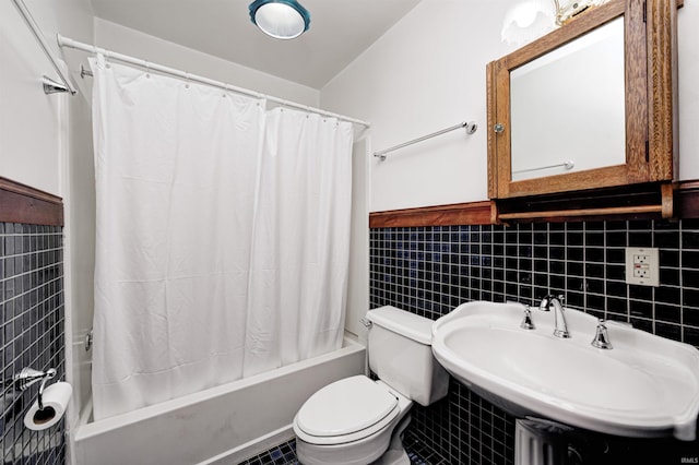 4302 Kessler Blvd N Drive, Indianapolis, IN 46220 - bathroom with shower / tub combo with curtain, a sink, tile walls, toilet, and a wainscoted wall
