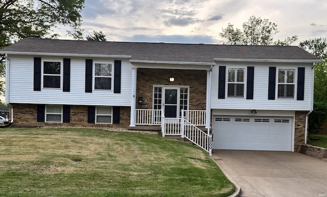 3200 Mockingbird Ln, Evansville, IN 47710 - raised ranch with brick siding, driveway, a garage, and a front lawn