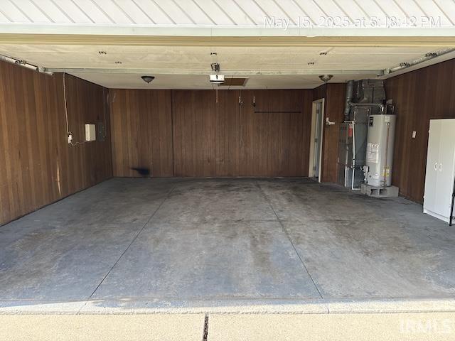 4415 Richfield Ln, Fort Wayne, IN 46816 - garage with water heater, a garage door opener, and wood walls