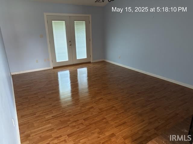 4415 Richfield Ln, Fort Wayne, IN 46816 - empty room featuring french doors, baseboards, and wood finished floors