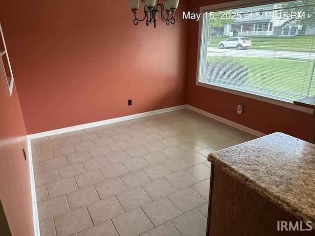 4415 Richfield Ln, Fort Wayne, IN 46816 - unfurnished dining area featuring a chandelier and baseboards