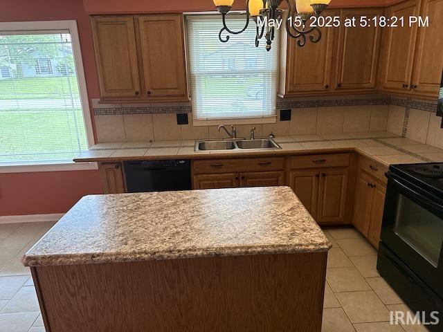 4415 Richfield Ln, Fort Wayne, IN 46816 - kitchen featuring a sink, black appliances, light tile patterned flooring, and plenty of natural light
