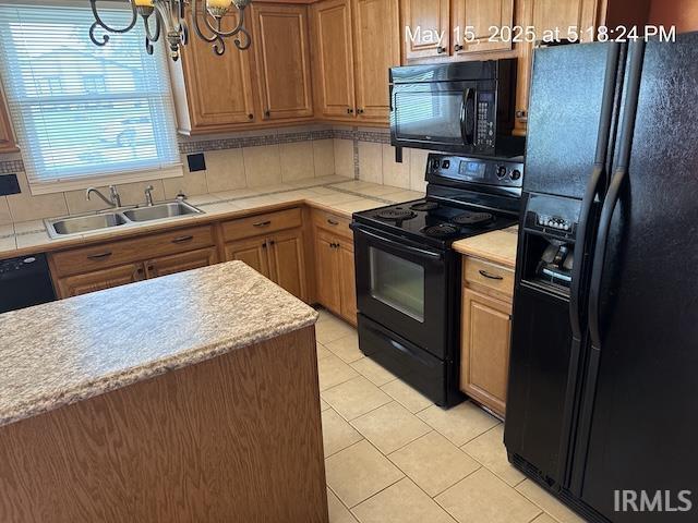4415 Richfield Ln, Fort Wayne, IN 46816 - kitchen with black appliances, a sink, a chandelier, decorative backsplash, and light tile patterned floors