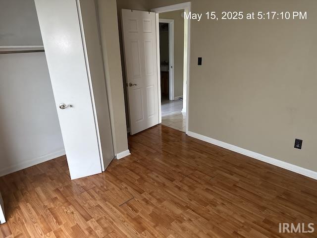 4415 Richfield Ln, Fort Wayne, IN 46816 - unfurnished bedroom featuring baseboards, wood finished floors, and a closet