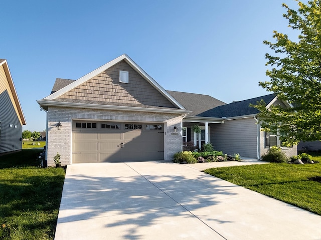224 Aqueduct Cir, West Lafayette, IN 47906 - craftsman inspired home featuring driveway, a garage, brick siding, and a front lawn