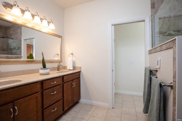 224 Aqueduct Cir, West Lafayette, IN 47906 - bathroom featuring double vanity, tiled shower, tile patterned floors, and baseboards